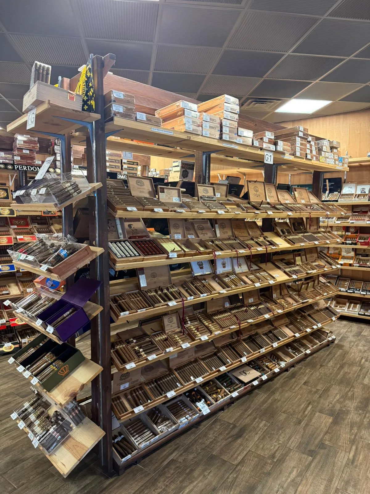 Inside the humidor at Cigar Heaven — a central island stocked with cigar boxes from Padron, Arturo Fuente, My Father, and dozens of other brands. Webster, TX.