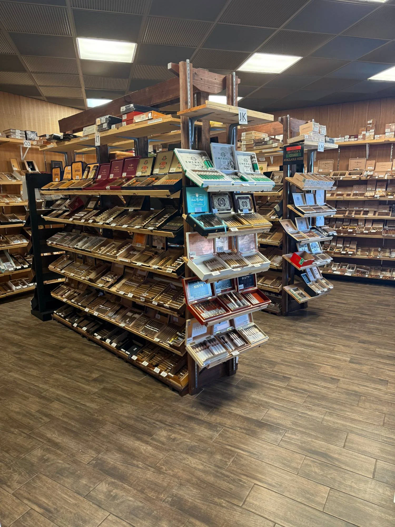 A freestanding display island in the Cigar Heaven humidor with Rocky Patel boxes up front and full shelves behind.