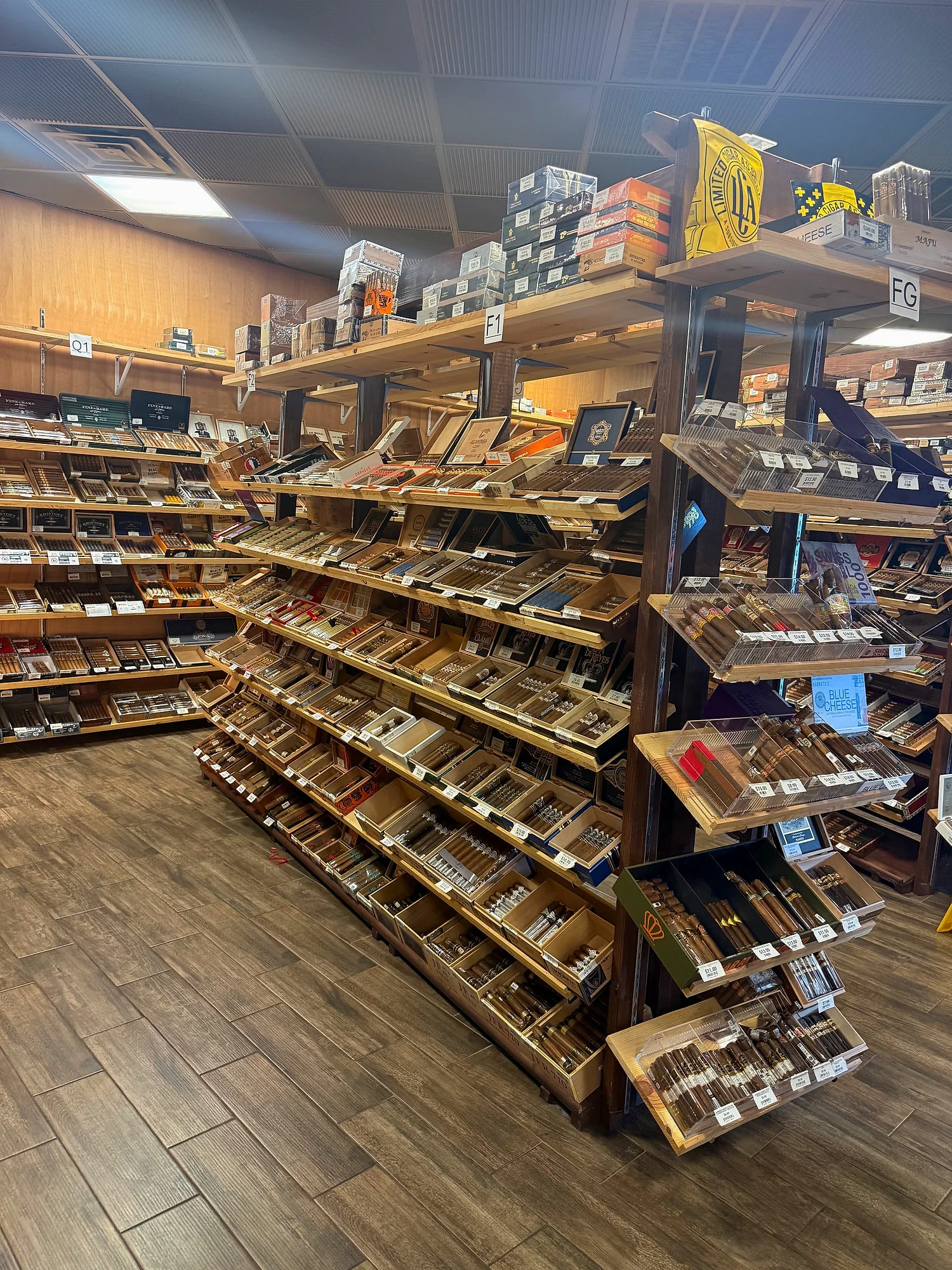 A double-sided shelving island with Limited Cigar Association releases on top, in the Cigar Heaven humidor.