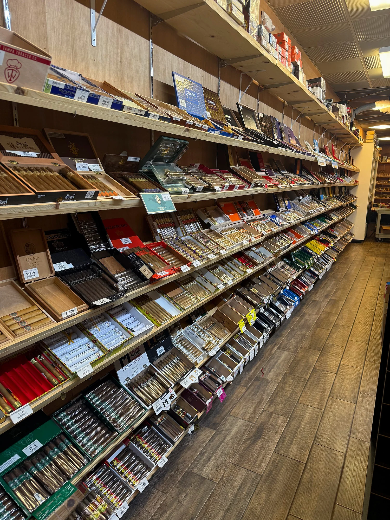A long wall of Macanudo, Cohiba, Diesel and other boxes in the Cigar Heaven humidor.
