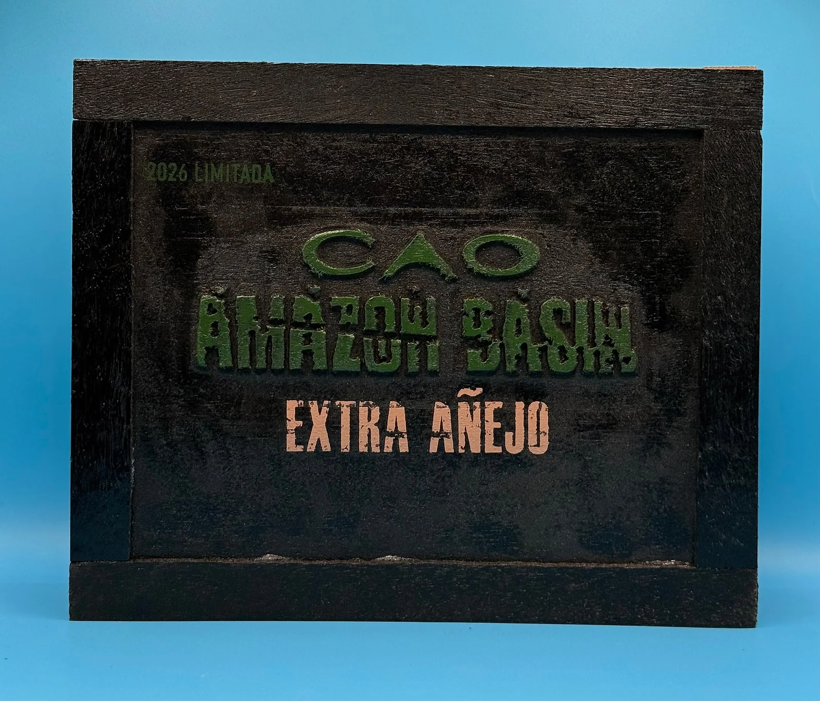 The dark wooden box of CAO Amazon Basin Extra Añejo, 2026 Limitada, with green and peach lettering.