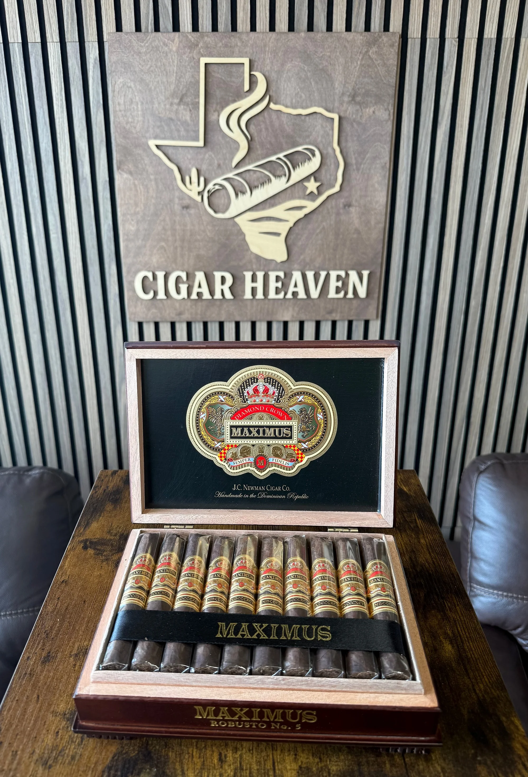 An open box of Diamond Crown Maximus Robusto No. 5 cigars by J.C. Newman, under the Cigar Heaven sign in the lounge.