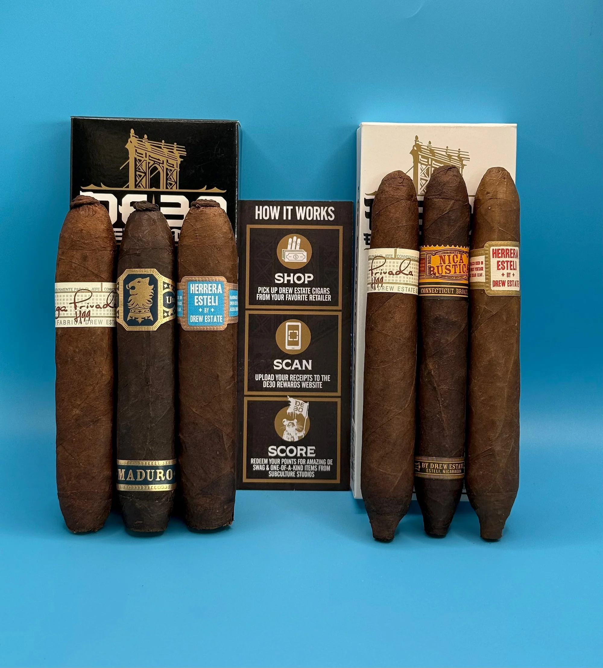 Drew Estate DE-30 Limited Edition Feral Pig and Suprema cigars — Liga Privada H99, Undercrown Maduro, Herrera Estelí and Nica Rustica — with their black and white packs.